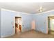 Bedroom featuring light blue wood paneled walls and multiple doorways at 2009 S L St, Elwood, IN 46036