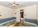 This is a bedroom featuring an open door, wallpaper, and original trim at 2009 S L St, Elwood, IN 46036