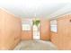 A room with wood paneling, three windows and a view to the yard outside at 2009 S L St, Elwood, IN 46036