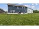 Back of a blue two-story house with green lawn and a concrete patio featuring chairs and a grill at , Westfield, IN 46074