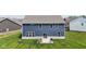 Backyard of a blue two-story house with green lawn and a concrete patio featuring chairs and a grill at , Westfield, IN 46074