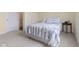 Well-lit bedroom featuring neutral carpeting, soft yellow walls, and a cozy striped bedspread at , Westfield, IN 46074