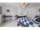 A bright bedroom with a ceiling fan, checkered bedspread, and a work desk at , Westfield, IN 46074