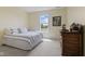 Bright bedroom featuring a large window, carpeted floor, and a striped comforter on the bed at , Westfield, IN 46074