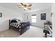 A well-lit bedroom featuring a ceiling fan, a work desk and an inviting bed at , Westfield, IN 46074