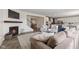 Spacious living room open to the kitchen with a fireplace, modern lighting, and hardwood floors at , Westfield, IN 46074