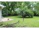 Large backyard with mature trees and a concrete patio at 2232 Fairview St, Anderson, IN 46016