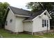 Exterior view of home with vinyl siding, black roof and manicured lawn at 2232 Fairview St, Anderson, IN 46016