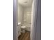 Modern bathroom with a tub/shower combo, white vanity, and wood-style flooring at 2540 Lullwater Ln, Indianapolis, IN 46229