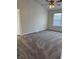 Neutral-toned bedroom featuring plush carpeting, a ceiling fan, and a window with blinds at 2540 Lullwater Ln, Indianapolis, IN 46229