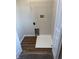 Spacious laundry room featuring sleek wood floors and modern appliances at 2540 Lullwater Ln, Indianapolis, IN 46229