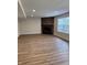 Bright living room features a stone fireplace, recessed lighting, and wood-look floors at 2540 Lullwater Ln, Indianapolis, IN 46229