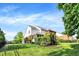 Beautifully landscaped backyard showing a two-story home with green lawn and mature trees at 2614 Daylily Ct, Westfield, IN 46074