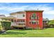 Stunning backyard with large red brick house featuring a screened in porch and well-manicured lawn at 2614 Daylily Ct, Westfield, IN 46074