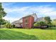 Large, well-maintained backyard with lush green grass and brick home with screened in porch at 2614 Daylily Ct, Westfield, IN 46074
