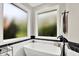 Bright bathroom featuring a modern soaking tub with matte black finishes and two large windows for natural light at 2614 Daylily Ct, Westfield, IN 46074