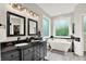 Modern bathroom featuring double vanities, a soaking tub, and ample natural light, creating a spa-like atmosphere at 2614 Daylily Ct, Westfield, IN 46074