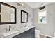 Stylish bathroom featuring double sinks, marble countertop, and framed mirrors at 2614 Daylily Ct, Westfield, IN 46074