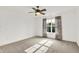 Sun-filled bedroom with carpet, ceiling fan, and a large window dressed in patterned curtains at 2614 Daylily Ct, Westfield, IN 46074