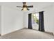 Airy bedroom with a view from the window complemented by dark curtains and a ceiling fan at 2614 Daylily Ct, Westfield, IN 46074