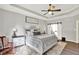 Stylish bedroom with neutral decor, a ceiling fan, and a window, creating a relaxing and inviting atmosphere at 2614 Daylily Ct, Westfield, IN 46074