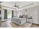 Cozy bedroom with tray ceilings, ceiling fan, carpet, and a large window providing natural light and a view at 2614 Daylily Ct, Westfield, IN 46074
