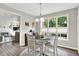Dining area with plenty of natural light, white chairs and view to Gathering room with fireplace at 2614 Daylily Ct, Westfield, IN 46074