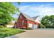 Exterior view of a well-maintained brick home with a three-car garage and landscaped front yard at 2614 Daylily Ct, Westfield, IN 46074