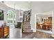 Grand foyer featuring high ceilings, a staircase with iron railings, and views into the dining and living areas at 2614 Daylily Ct, Westfield, IN 46074