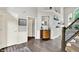 Elegant foyer with wood floors, a staircase, and decorative shelving that adds visual interest and provides display space at 2614 Daylily Ct, Westfield, IN 46074