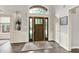 Inviting foyer with wood floors, a decorative rug, and a stylish front door featuring sidelights and a transom window at 2614 Daylily Ct, Westfield, IN 46074