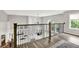 Upstairs hallway with dark wood floors and decorative railing overlooking the living room at 2614 Daylily Ct, Westfield, IN 46074