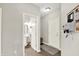 Hallway with wood floors features a door to a convenient half bathroom with a pedestal sink at 2614 Daylily Ct, Westfield, IN 46074