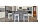 This kitchen features a granite island, stainless steel appliances, and white cabinets at 2614 Daylily Ct, Westfield, IN 46074