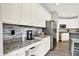 Kitchen with white cabinets, granite countertop desk space, and stainless steel refrigerator at 2614 Daylily Ct, Westfield, IN 46074