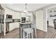 Modern kitchen with white cabinetry, stainless steel appliances, a gray island, and hardwood flooring at 2614 Daylily Ct, Westfield, IN 46074