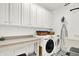 Functional laundry room featuring a countertop, washer, dryer, and ample cabinet space at 2614 Daylily Ct, Westfield, IN 46074