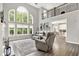 Elegant living room with soaring ceilings, large windows, and comfortable gray reclining furniture at 2614 Daylily Ct, Westfield, IN 46074