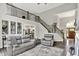 Open-concept living room with a staircase, a fireplace, and views into the dining area at 2614 Daylily Ct, Westfield, IN 46074
