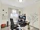 Office space with a modern desk setup, decorations, and natural light from the window at 2614 Daylily Ct, Westfield, IN 46074