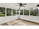 Relaxing sunroom with wood floors and white trim windows overlooking a lush green yard at 2614 Daylily Ct, Westfield, IN 46074