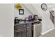 Basement wet bar with sink, mini refrigerator, and wooden cabinets at 2614 Daylily Ct, Westfield, IN 46074