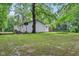 Expansive backyard featuring green lawn, play equipment and the back of the house at 2640 S Silcox Rd, Paragon, IN 46166