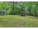 Spacious backyard with lush greenery, scattered trees, and recreational elements at 2640 S Silcox Rd, Paragon, IN 46166