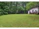 The property boasts an expansive backyard, perfect for recreation and relaxation by the patio at 2640 S Silcox Rd, Paragon, IN 46166