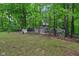 A fully fenced chicken coop and yard on a lush green property with mature trees providing shade and privacy at 2640 S Silcox Rd, Paragon, IN 46166