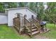 The wooden deck, equipped with a grill and outdoor seating, is perfect for entertaining and relaxing outdoors at 2640 S Silcox Rd, Paragon, IN 46166
