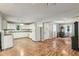 Open concept kitchen with white cabinets, hardwood floors, and updated appliances at 2640 S Silcox Rd, Paragon, IN 46166