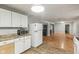 Spacious kitchen includes wood floors, white cabinets, and stainless steel appliances at 2640 S Silcox Rd, Paragon, IN 46166