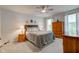 Comfortable bedroom with neutral tones, plush bedding, ceiling fan, and natural lighting at 2747 Stonebridge Dr, Lebanon, IN 46052